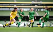 31 May 2023; Aine Doherty of Scoil Colmcille, Kerrykeel, Donegal, left, in action against Ciara McGinty and Mairéad Mullins, 5, of Castleblakeney NS, Galway, during the ‘A’ Girls Cup, for small sized schools, at the FAI Primary School 5s National Finals in the Aviva Stadium, Dublin. Photo by Stephen McCarthy/Sportsfile