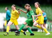 31 May 2023; Mairéad Mullins of Castleblakeney NS, Galway, in action against Cliodhna Robinson, left, and Aishling Duffy of Scoil Colmcille, Kerrykeel, Donegal, during the ‘A’ Girls Cup, for small sized schools, at the FAI Primary School 5s National Finals in the Aviva Stadium, Dublin. Photo by Stephen McCarthy/Sportsfile