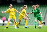 31 May 2023; Mairéad Mullins of Castleblakeney NS, Galway, right, in action against Ciara McVeigh Crossan and Cliodhna Robinson, left, of Scoil Colmcille, Kerrykeel, Donegal, during the ‘A’ Girls Cup, for small sized schools, at the FAI Primary School 5s National Finals in the Aviva Stadium, Dublin. Photo by Stephen McCarthy/Sportsfile