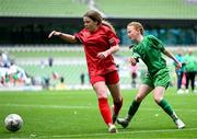 31 May 2023; Jenna-Rose Ní Chearúil of Gaelscoil Mhic Amhlaigh, Galway, (green) in action against Lucy Ní Choitir of Gaelscoil Charraig Uí Leighin, Cork, (red) during the ‘C’ Girls Cup, for large sized schools, at the FAI Primary School 5s National Finals in the Aviva Stadium, Dublin. Photo by Stephen McCarthy/Sportsfile