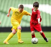 31 May 2023; Danny Bradley of Scoil Íosagáin, Buncrana, Donegal, left, in action against Seán Connors of St Anne’s School, Ennis, Clare, during the Special Schools Cup at the FAI Primary School 5s National Finals in the Aviva Stadium, Dublin. Photo by Stephen McCarthy/Sportsfile