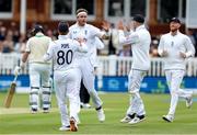 1 June 2023; Stuart Broad of England, centre, celebrates with teammates after taking the wicket of Andrew Balbirnie of Ireland during day one of the Test Match between England and Ireland at Lords Cricket Ground in London, England. Photo by Matt Impey/Sportsfile
