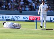 2 June 2023; James McCollum of Ireland twists his ankle after avoiding a ball bowled by Josh Tongue of England and has to leave the field injured, England captain `ben Stokes (right) winces, during day two of the Test Match between England and Ireland at Lords Cricket Ground in London, England. Photo by Matt Impey/Sportsfile