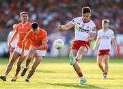 3 June 2023; Michael McKernan of Tyrone kicks a point despite the efforts of Conor O'Neill of Armagh during the GAA Football All-Ireland Senior Championship Round 2 match between Tyrone and Armagh at O'Neill's Healy Park in Omagh, Tyrone. Photo by Brendan Moran/Sportsfile