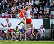 3 June 2023; Brian Kennedy of Tyrone catches a kickout ahead of Shane McPartlan and Jarly Óg Burns of Armagh during the GAA Football All-Ireland Senior Championship Round 2 match between Tyrone and Armagh at O'Neill's Healy Park in Omagh, Tyrone. Photo by Brendan Moran/Sportsfile