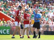 4 June 2023; Darragh O'Sullivan of Cork, centre, is shown a yellow card by referee Chris Mooney during the O’Neills.com GAA Hurling All-Ireland U20 Championship Final match between Cork and Offaly at FBD Semple Stadium in Thurles, Tipperary. Photo by Michael P Ryan/Sportsfile