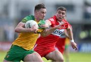 4 June 2023; Ciaran Thompson of Donegal is tackled by Ciaran McFaul of Derry during the GAA Football All-Ireland Senior Championship Round 2 match between Donegal and Derry at MacCumhaill Park in Ballybofey, Donegal. Photo by Brendan Moran/Sportsfile