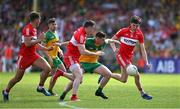 4 June 2023; Jamie Brennan of Donegal in action against Derry players, from left, Shane McGuigan, Gareth McKinless and Ethan Doherty during the GAA Football All-Ireland Senior Championship Round 2 match between Donegal and Derry at MacCumhaill Park in Ballybofey, Donegal. Photo by Brendan Moran/Sportsfile