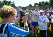 4 June 2023; Monaghan supporter Bernie McKenna, from Truagh, Co Monaghan, takes a photo of her son Paul, with Conor McManus of Monaghan after the GAA Football All-Ireland Senior Championship Round 2 match between Monaghan and Clare at St Tiernach's Park in Clones, Monaghan. Photo by Daire Brennan/Sportsfile