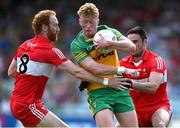 4 June 2023; Oisin Gallen of Donegal is tackled by Conor Glass, left, and Christopher McKaigue of Derry during the GAA Football All-Ireland Senior Championship Round 2 match between Donegal and Derry at MacCumhaill Park in Ballybofey, Donegal. Photo by Brendan Moran/Sportsfile