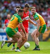4 June 2023; Shane McGuigan of Derry is tackled by Daire Ó Baoill of Donegal during the GAA Football All-Ireland Senior Championship Round 2 match between Donegal and Derry at MacCumhaill Park in Ballybofey, Donegal. Photo by Brendan Moran/Sportsfile
