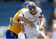 4 June 2023; Galway goalkeeper Shane Murray is tackled by Mark O'Brien of Clare during the Electric Ireland GAA Hurling All-Ireland Minor Championship Final match between Clare and Galway at FBD Semple Stadium in Thurles, Tipperary. Photo by Michael P Ryan/Sportsfile