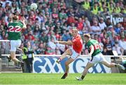 4 June 2023; Conor Grimes of Louth kicks a point under pressure from Mayo players Donnacha McHugh, left, and Ryan O'Donoghue during the GAA Football All-Ireland Senior Championship Round 2 match between Mayo and Louth at Hastings Insurance MacHale Park in Castlebar, Mayo. Photo by Seb Daly/Sportsfile