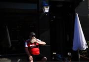 5 June 2023; A St Patrick's Athletic supporter drinks a pint in the sun before the SSE Airtricity Men's Premier Division match between St Patrick's Athletic and Derry City at Richmond Park in Dublin. Photo by Harry Murphy/Sportsfile
