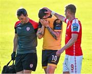 5 June 2023; Patrick McEleney of Derry City, centre, is consoled by Eoin Doyle of St Patrick's Athletic, as he leaves the field, accompanied by Derry physiotherapist Michael Hegarty, during the SSE Airtricity Men's Premier Division match between St Patrick's Athletic and Derry City at Richmond Park in Dublin. Photo by Harry Murphy/Sportsfile