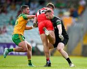 4 June 2023; Donegal goalkeeper Shaun Patton, right, and Brendan McCole tackle Shane McGuigan of Derry during the GAA Football All-Ireland Senior Championship Round 2 match between Donegal and Derry at MacCumhaill Park in Ballybofey, Donegal. Photo by Brendan Moran/Sportsfile