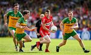 4 June 2023; Gareth McKinless of Derry in action against Donegal players, from left, Jason McGee, Odhran Doherty and Ciaran Thompson during the GAA Football All-Ireland Senior Championship Round 2 match between Donegal and Derry at MacCumhaill Park in Ballybofey, Donegal. Photo by Brendan Moran/Sportsfile
