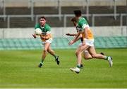 10 June 2023; Jordan Hayes of Offaly hand-passes to a team-mate during the Tailteann Cup Preliminary Quarter Final match between Offaly and Wexford at Glenisk O'Connor Park in Tullamore, Offaly. Photo by Tom Beary/Sportsfile