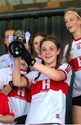 10 June 2023; Derry captain Aine Young lifts the cup after the 2023 All-Ireland U14 Gold Final between Derry and Tipperary at Clan na Gael GAA Club in Dundalk, Louth. Photo by Stephen Marken/Sportsfile