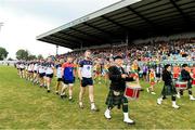 10 June 2023; New York captain Johnny Glynn leads his team-mates during the parade before the Tailteann Cup Preliminary Quarter Final match between Carlow and New York at Netwatch Cullen Park in Carlow. Photo by Matt Browne/Sportsfile