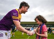 10 June 2023; Ben Brosnan of Wexford signs an autograph for a young supporter after the Tailteann Cup Preliminary Quarter Final match between Offaly and Wexford at Glenisk O'Connor Park in Tullamore, Offaly. Photo by Tom Beary/Sportsfile