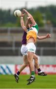 10 June 2023; Jordan Hayes of Offaly in action against Michael Furlong of Wexford during the Tailteann Cup Preliminary Quarter Final match between Offaly and Wexford at Glenisk O'Connor Park in Tullamore, Offaly. Photo by Tom Beary/Sportsfile