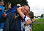 10 June 2023; A Wicklow player celebrates with a family member after the 2023 All-Ireland U14 Bronze Final match between Clare and Wicklow at McDonagh Park in Nenagh, Tipperary. Photo by Michael P Ryan/Sportsfile