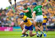 11 June 2023; Mark Rodgers of Clare is tackled by Gearoid Hegarty , left, and Michael Casey of Limerick during the Munster GAA Hurling Championship Final match between Clare and Limerick at TUS Gaelic Grounds in Limerick. Photo by Eóin Noonan/Sportsfile