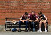11 June 2023; Galway supporters the Moran family, from left, Oisin, Cathal, and Owen, from Portumna, Galway, watch the Munster Senior Hurling Championship Final match on a mobile phone before the Leinster GAA Hurling Championship Final match between Kilkenny and Galway at Croke Park in Dublin. Photo by Seb Daly/Sportsfile
