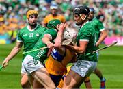 11 June 2023; Adam Hogan of Clare is tackled by William O'Donoghue and Gearoid Hegarty of Limerick in the last seconds of the Munster GAA Hurling Championship Final match between Clare and Limerick at TUS Gaelic Grounds in Limerick.