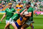 11 June 2023; Adam Hogan of Clare is tackled by William O'Donoghue and Gearoid Hegarty of Limerick in the last seconds of the Munster GAA Hurling Championship Final match between Clare and Limerick at TUS Gaelic Grounds in Limerick. Photo by Ray McManus/Sportsfile