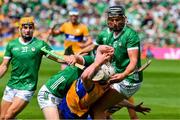 11 June 2023; Adam Hogan of Clare is tackled by William O'Donoghue and Gearoid Hegarty of Limerick in the last seconds of the Munster GAA Hurling Championship Final match between Clare and Limerick at TUS Gaelic Grounds in Limerick. Photo by Ray McManus/Sportsfile