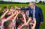 13 June 2023; At the 2023 GAA Hurling All-Ireland Series national launch at De La Salle GAA Club in Waterford is Uachtarán Chumann Lúthchleas Gael Larry McCarthy with children from the 9 to 10 year old players of the host club De La Salle. Photo by Ray McManus/Sportsfile