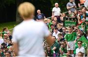 16 June 2023; Republic of Ireland supporter Emily Keegan, age 9, from Tallaght, Dublin, stands up in the crowd as manager Vera Pauw speaks to supporter during a Republic of Ireland women open training session at UCD Bowl in Dublin. Photo by Ramsey Cardy/Sportsfile