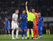 16 June 2023; Referee Harald Lechner shows the yellow card to James McClean of Republic of Ireland and Tasos Bakasetas of Greece, 11, during the UEFA EURO 2024 Championship qualifying group B match between Greece and Republic of Ireland at the OPAP Arena in Athens, Greece. Photo by Stephen McCarthy/Sportsfile