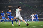 16 June 2023; A laser is seen in the crowd as Matt Doherty of Republic of Ireland is in action against Kostas Tsimikas of Greece during the UEFA EURO 2024 Championship qualifying group B match between Greece and Republic of Ireland at the OPAP Arena in Athens, Greece. Photo by Stephen McCarthy/Sportsfile