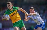 17 June 2023; Eoghan Ban Gallagher of Donegal in action against Ryan Wylie of Monaghan during the GAA Football All-Ireland Senior Championship Round 3 match between Monaghan and Donegal at O'Neills Healy Park in Omagh, Tyrone. Photo by Ramsey Cardy/Sportsfile