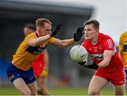 17 June 2023; Ethan Doherty of Derry in action against Pearse Lillis of Clare during the GAA Football All-Ireland Senior Championship Round 3 match between Derry and Clare at Glennon Brothers Pearse Park in Longford. Photo by Stephen Marken/Sportsfile