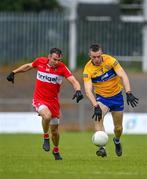17 June 2023; Benny Heron of Derry in action against Ciaran Russell of Clare during the GAA Football All-Ireland Senior Championship Round 3 match between Derry and Clare at Glennon Brothers Pearse Park in Longford. Photo by Stephen Marken/Sportsfile