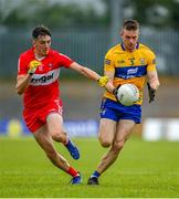 17 June 2023; Ciaran Russell of Clare in action against Paul Cassidy of Derry during the GAA Football All-Ireland Senior Championship Round 3 match between Derry and Clare at Glennon Brothers Pearse Park in Longford. Photo by Stephen Marken/Sportsfile