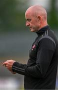 17 June 2023; Derry manager Ciaran Meenagh checks his phone during the GAA Football All-Ireland Senior Championship Round 3 match between Derry and Clare at Glennon Brothers Pearse Park in Longford. Photo by Stephen Marken/Sportsfile
