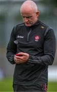 17 June 2023; Derry manager Ciaran Meenagh checks his phone during the GAA Football All-Ireland Senior Championship Round 3 match between Derry and Clare at Glennon Brothers Pearse Park in Longford. Photo by Stephen Marken/Sportsfile