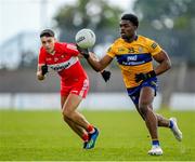 17 June 2023; Ikem Ugweru of Clare in action against Ben McCarron of Derry during the GAA Football All-Ireland Senior Championship Round 3 match between Derry and Clare at Glennon Brothers Pearse Park in Longford. Photo by Stephen Marken/Sportsfile