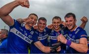 17 June 2023; Laois players, from left, Evan O'Carroll, Kevin Swayne, Ciaran Burke and Brian Daly celebrate after the Tailteann Cup Quarter Final match between Limerick and Laois at TUS Gaelic Grounds in Limerick. Photo by Tom Beary/Sportsfile