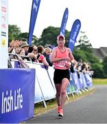 18 June 2023; Adrienne Jordan of Crusaders AC, Dublin, crosses the line to finish second in the women's event of the 2023 Irish Life Dublin Race Series – Corkagh Park 5 Mile at Corkagh Park in Clondalkin, Dublin. Photo by Sam Barnes/Sportsfile