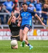18 June 2023; Colm Basquel of Dublin scores his side's second goal despite the tackle of Jack Lavin of Sligo during the GAA Football All-Ireland Senior Championship Round 3 match between Dublin and Sligo at Kingspan Breffni in Cavan. Photo by Ramsey Cardy/Sportsfile
