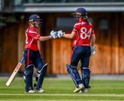 18 June 2023; Bella Armstrong of Dragons, left, celebrates with teammate Orla Prendergast after bringing up her century during the Evoke Super Series 2023 match between Typhoons and Dragons at YMCA Sports Ground on Claremont Road, Dublin. Photo by Piaras Ó Mídheach/Sportsfile