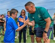 18 June 2023; FAI regional development officer Marc Kenny presents medals to players after the Football For All National Blitz on the Sport Ireland Campus in Dublin. Photo by Seb Daly/Sportsfile