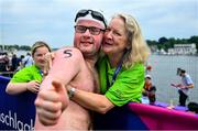 19 June 2023; Team Ireland's Eoin O'Connell, a member of D6 Special Olympics Club, from Dundrum, Dublin, with his mother Marie after the Open Water Swim 1,500m on day three of the World Special Olympic Games 2023 at the Grünau regatta course in Berlin, Germany. Photo by Ray McManus/Sportsfile
