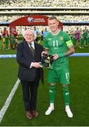 19 June 2023; Republic of Ireland captain James McClean, on the occassion of his 100th international cap, with the President of Ireland Michael D Higgins, before the UEFA EURO 2024 Championship qualifying group B match between Republic of Ireland and Gibraltar at the Aviva Stadium in Dublin. Photo by Stephen McCarthy/Sportsfile
